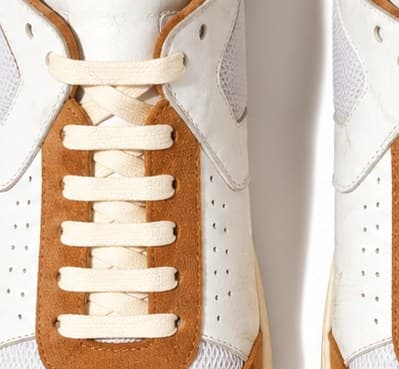 Cognac suede eyestay laced with waxed cream cord